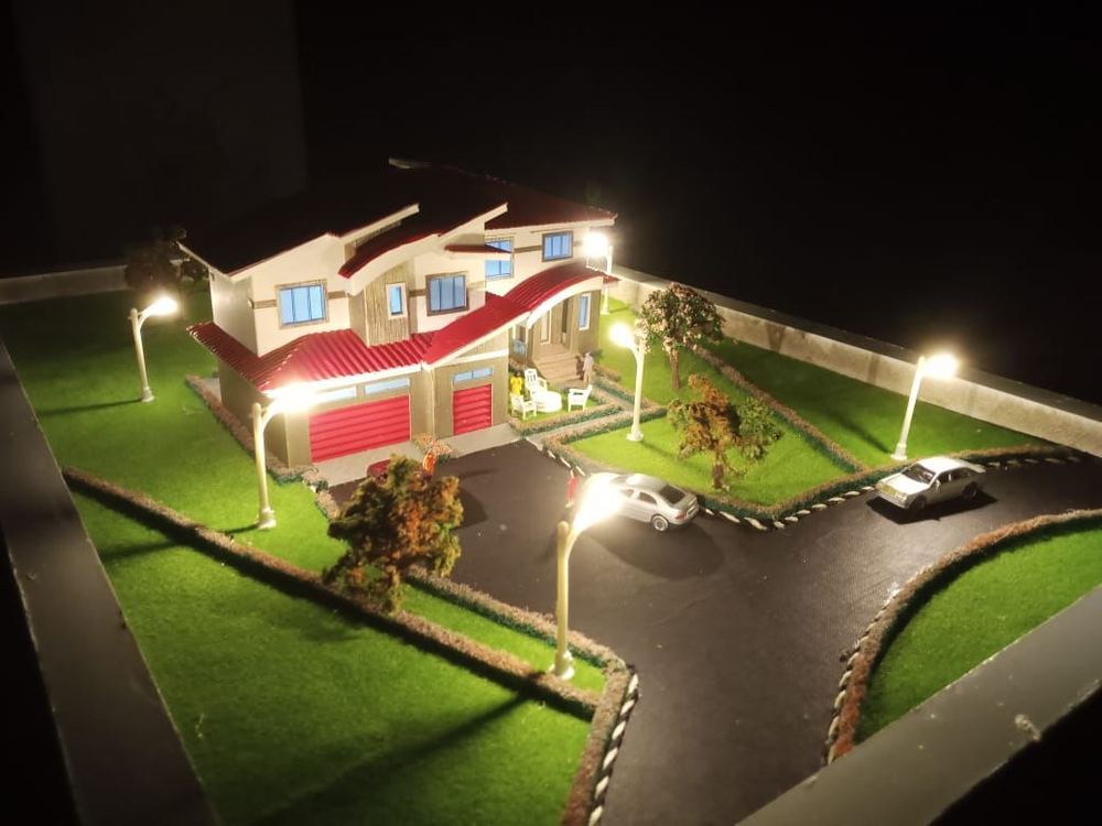 Handmade architectural model of a residential villa photographed lit at night