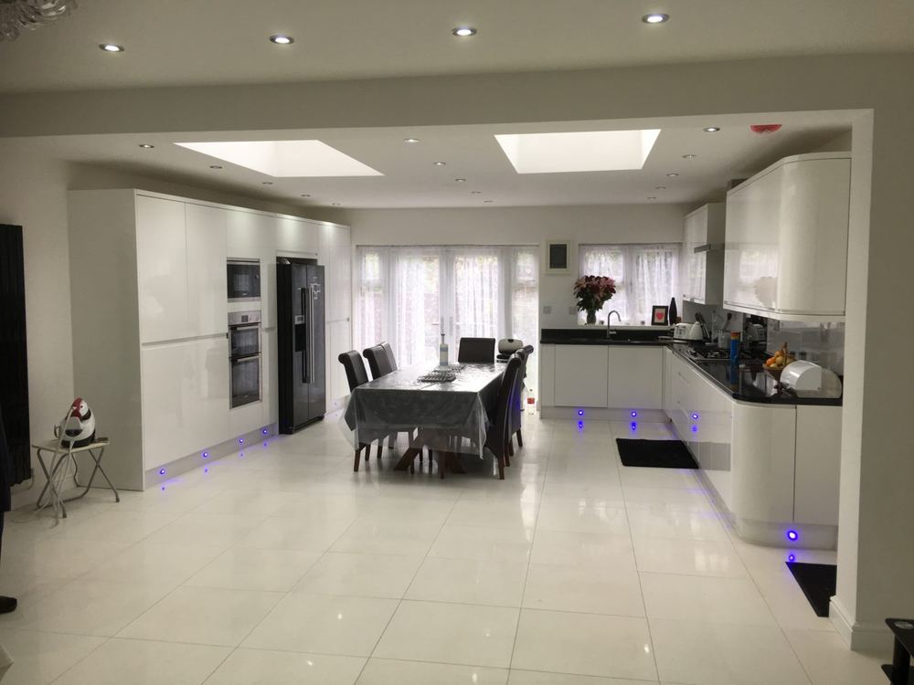 Bright open-plan kitchen and dining extension lit by a large roof lantern